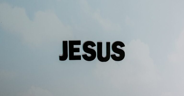 Minimalist image with bold 'JESUS' text against a cloudy sky background.