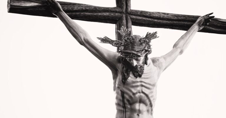 Monochrome depiction of Jesus crucified, showcasing religious artistry and sacrifice.