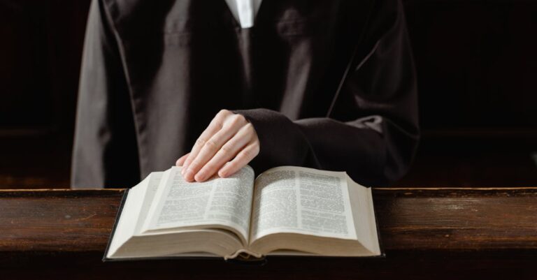 A person in religious attire reading an open Bible, highlighting the connection to spirituality.