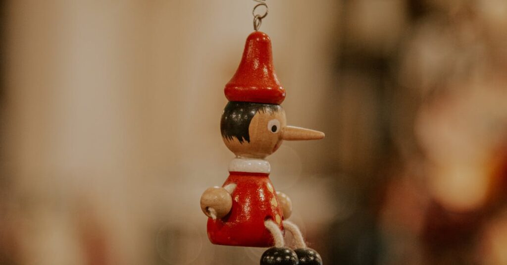 Detailed wooden Pinocchio ornament hanging amidst blurred festive decorations, embodying holiday charm.
