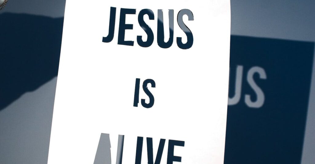 A person holding a white paper with the message 'Jesus is Alive' against a blue background.